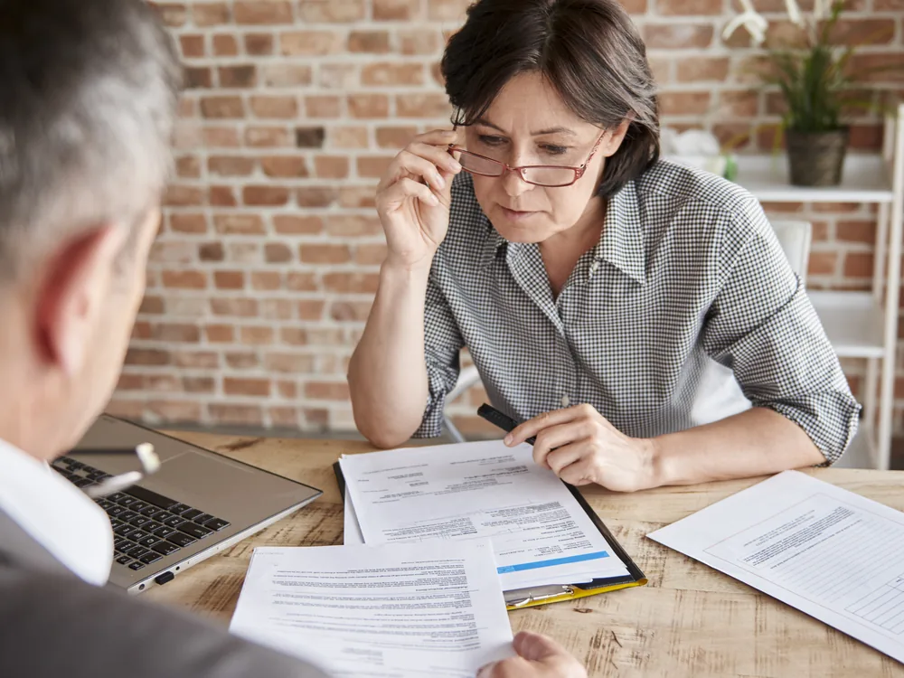 Advisors reviewing financial aid paperwork with a family