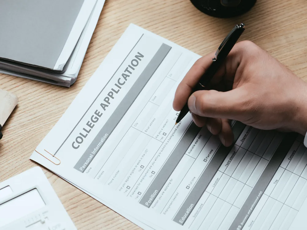Student completing a college application form