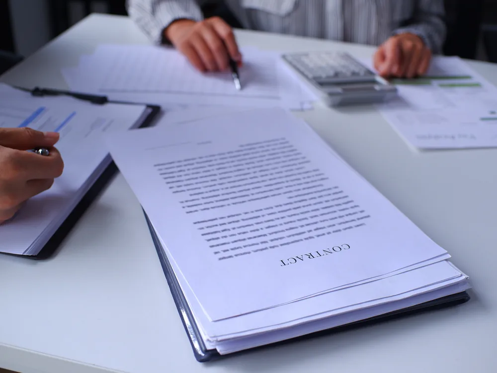 Advisors reviewing financial aid documents at a desk
